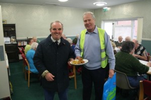 Lions Bill Thompson and Les Johnson serving fish and chips at Rillington Community Centre