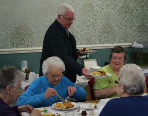 Lion Steve Garside serves fish and chips at Rillington Community Centre