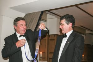 Past President Lion Nick presents Ian with his chain of office